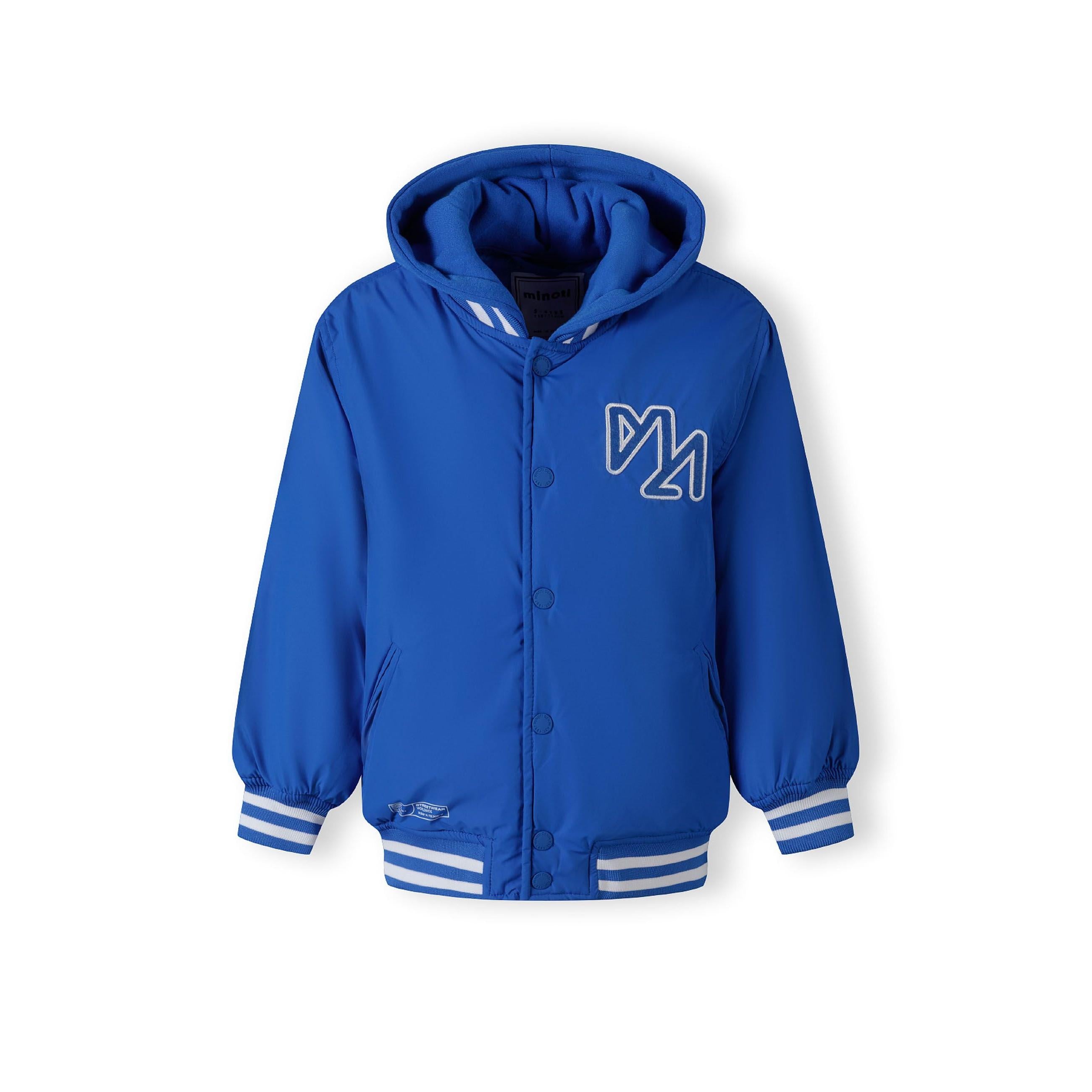 Close-up detail of white embroidered M logo on cobalt blue baseball jacket fabric