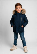 Boys winter parka in navy with faux fur hood, front view, featuring zippered and flap pockets.