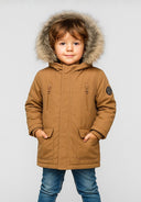 Boys hooded winter parka in beige, featuring faux fur trim, front pockets, and a zippered chest pocket.