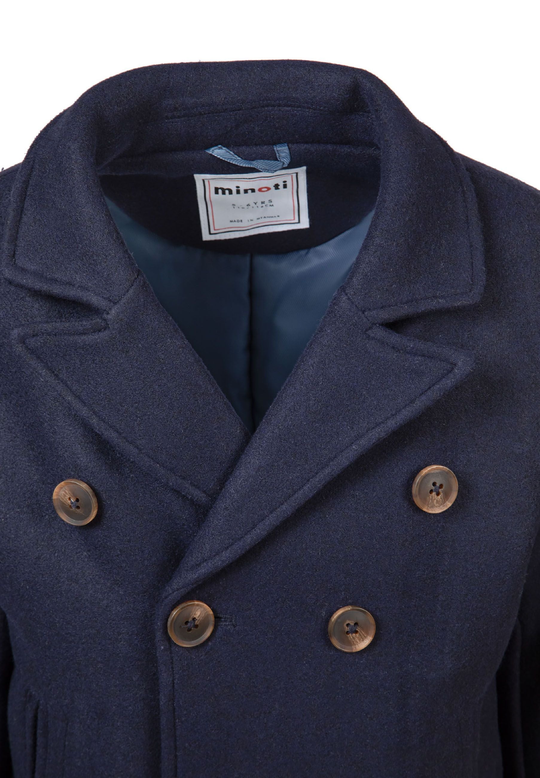 Close-up of a navy double-breasted boys coat with lapel and button fastening.