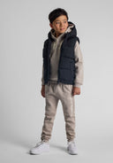 Boys black padded gilet, front view, with hood and zip pockets.