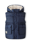 Boys navy gilet with hood, snap pockets, and high collar, front view.