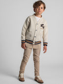 Boys cream buttoned sweatshirt with chest applique, front view, featuring two large patch pockets.