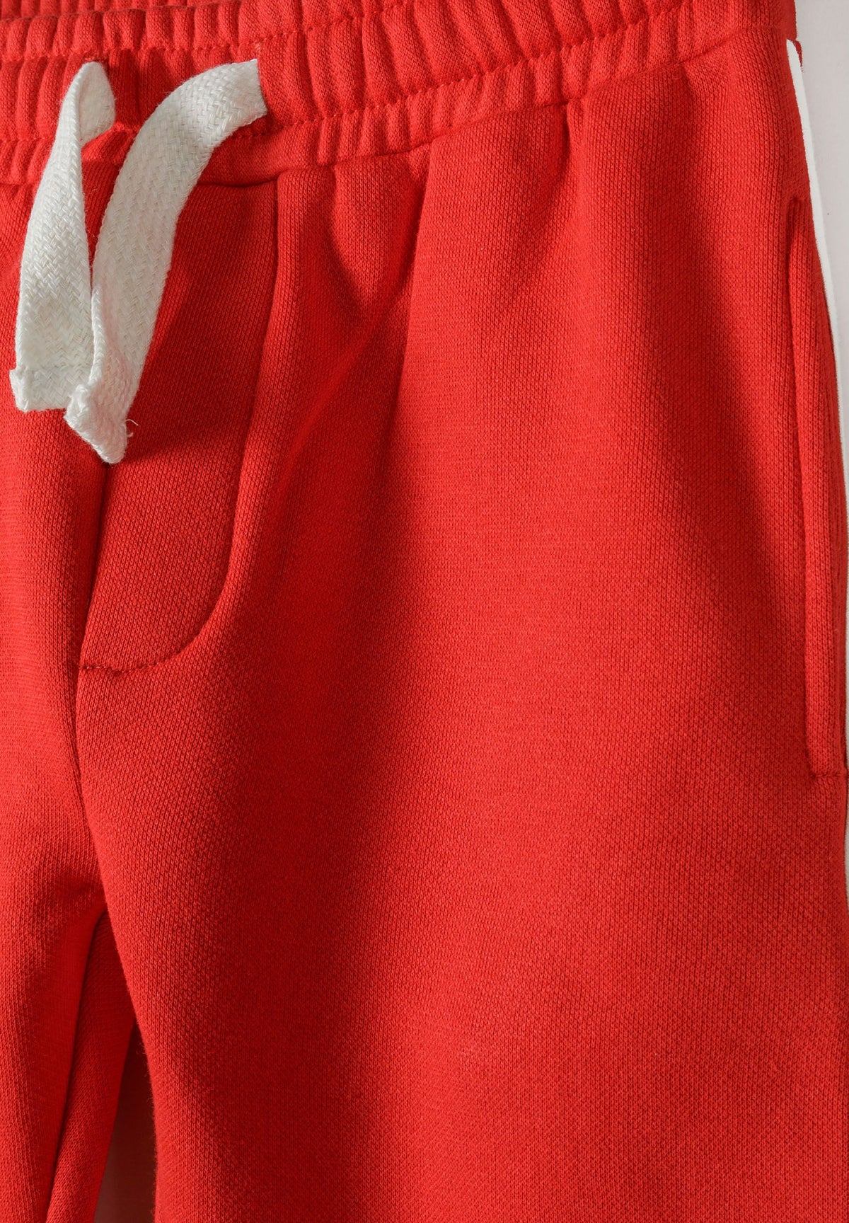 Red and cream sweatshirt and joggers set, drawstring and pocket detail.