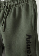 Detail of khaki joggers with 'Future Skate' print and elastic waistband.