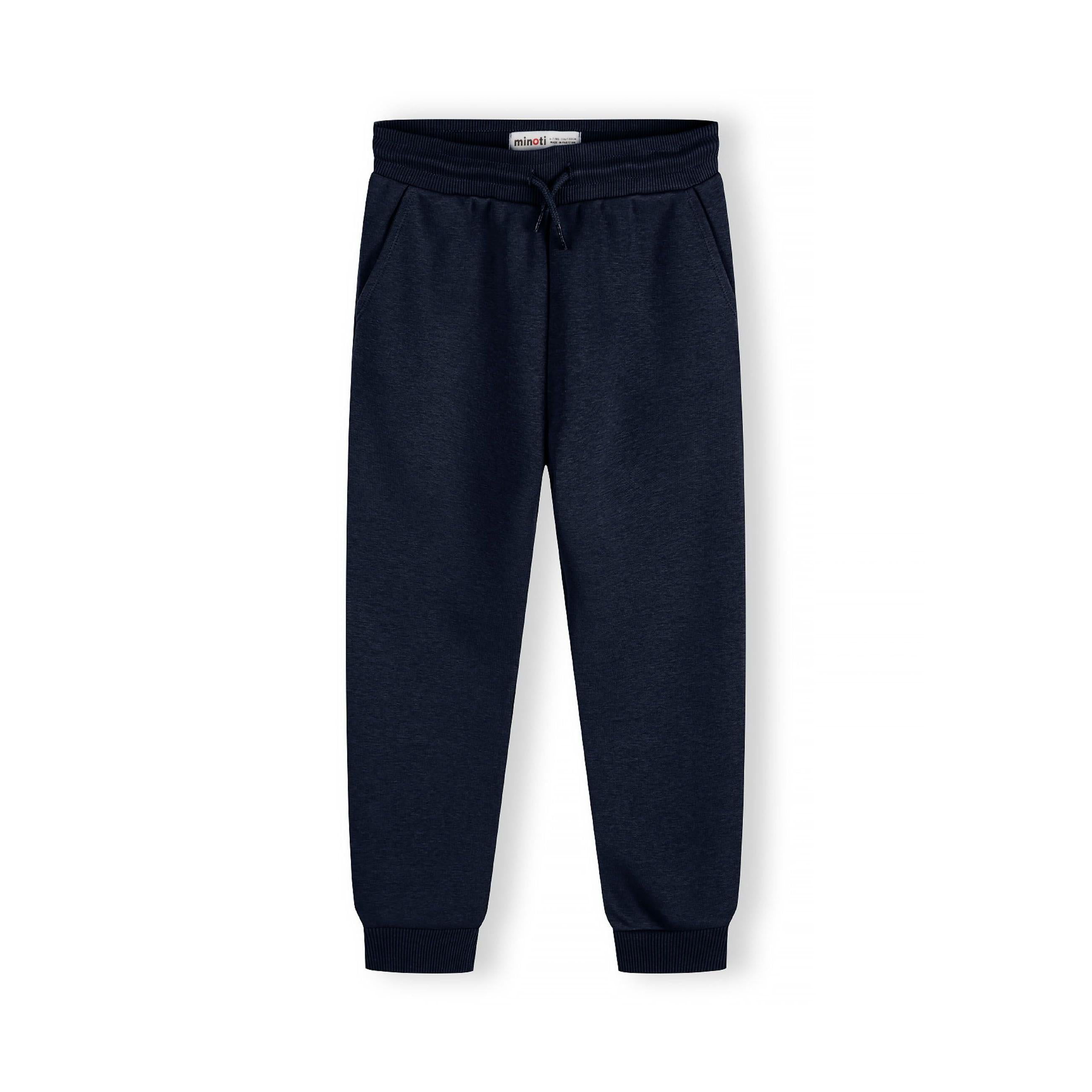 Close-up of navy Minoti joggers showing ribbed waistband with drawcord and soft sweat fabric texture on white background