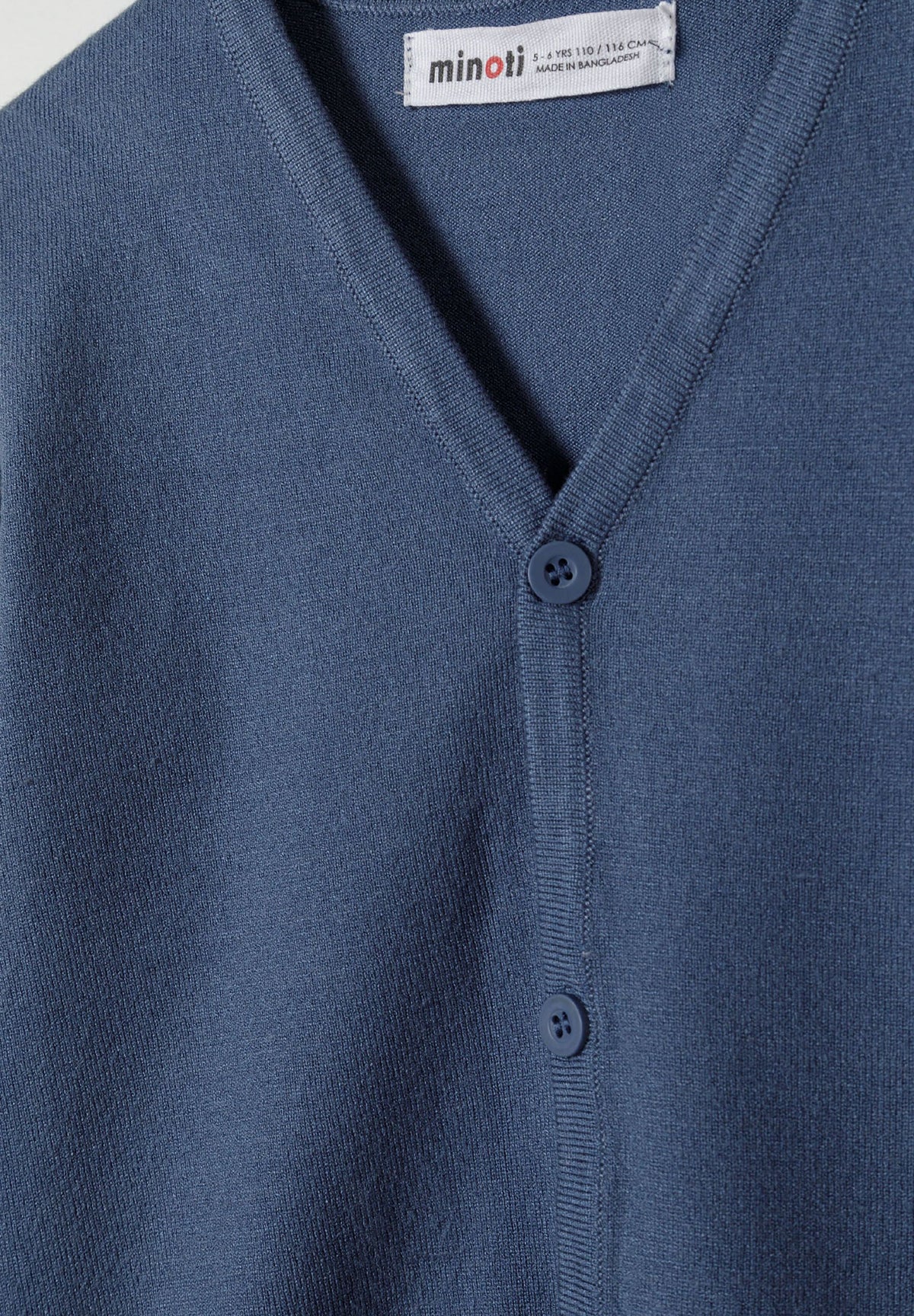 Blue v-neck cardigan, neckline and button detail.