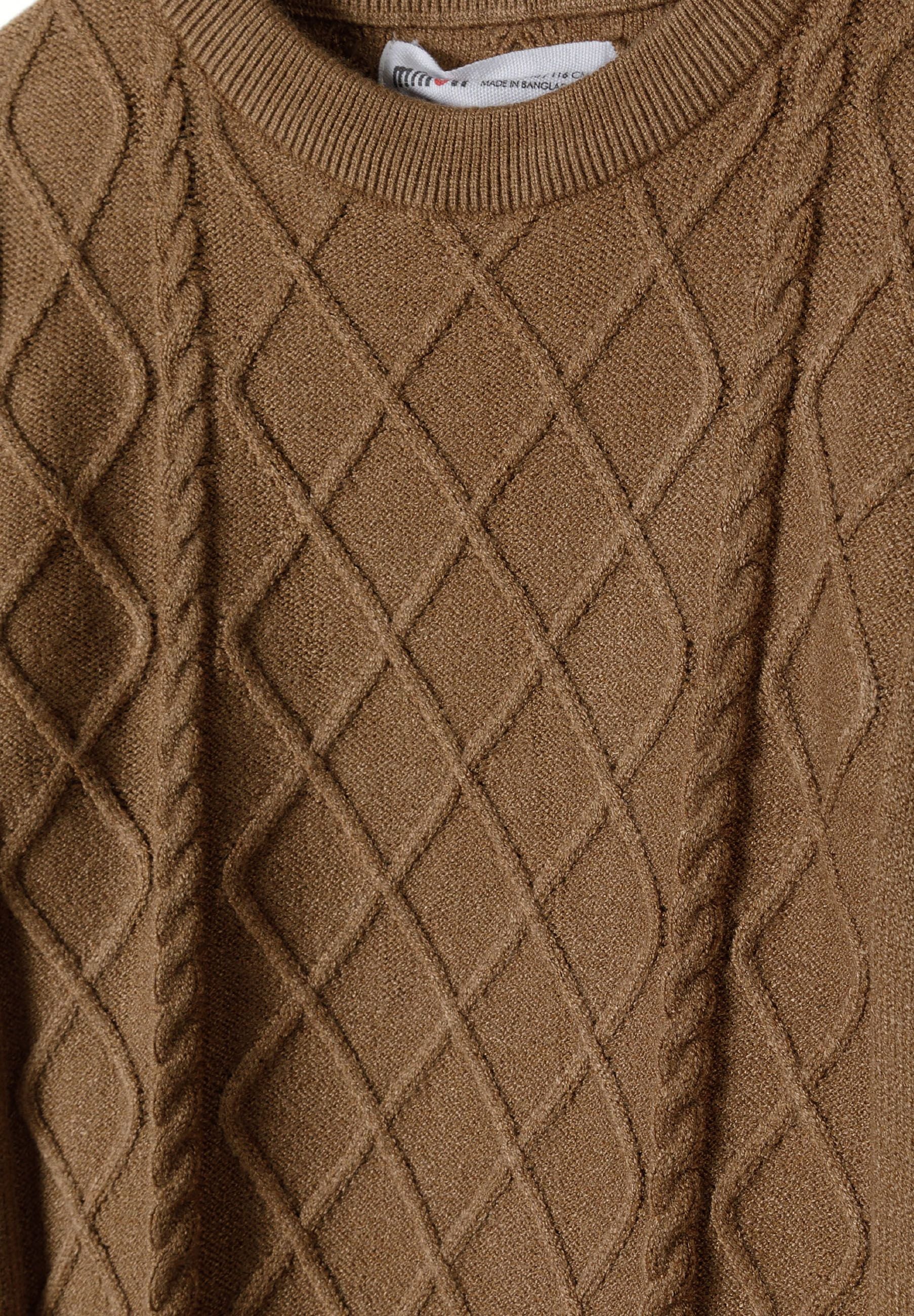 Close-up of boys brown cable knit crew neck sweater, showing diamond pattern.