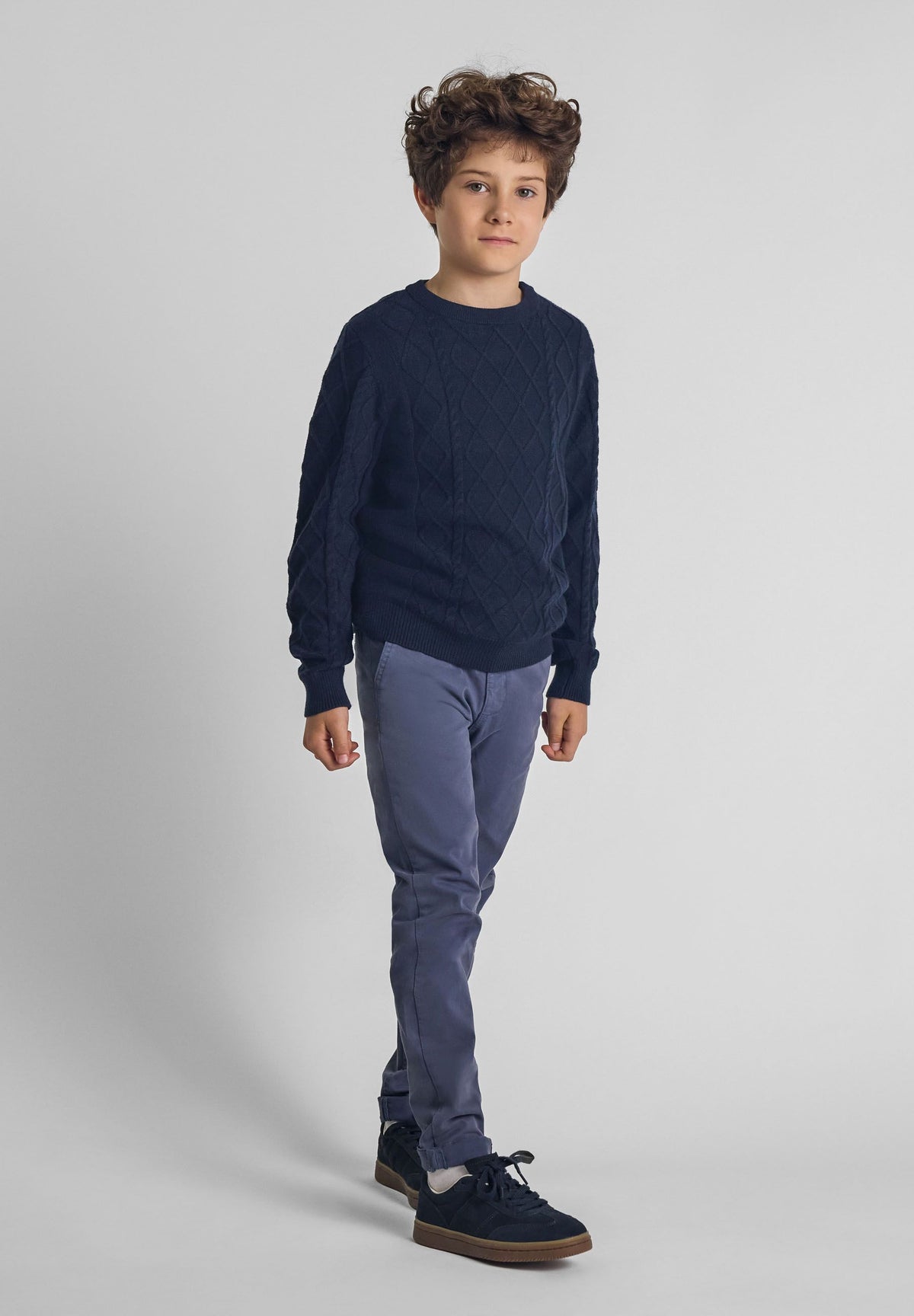Navy cable knit jumper, model front.