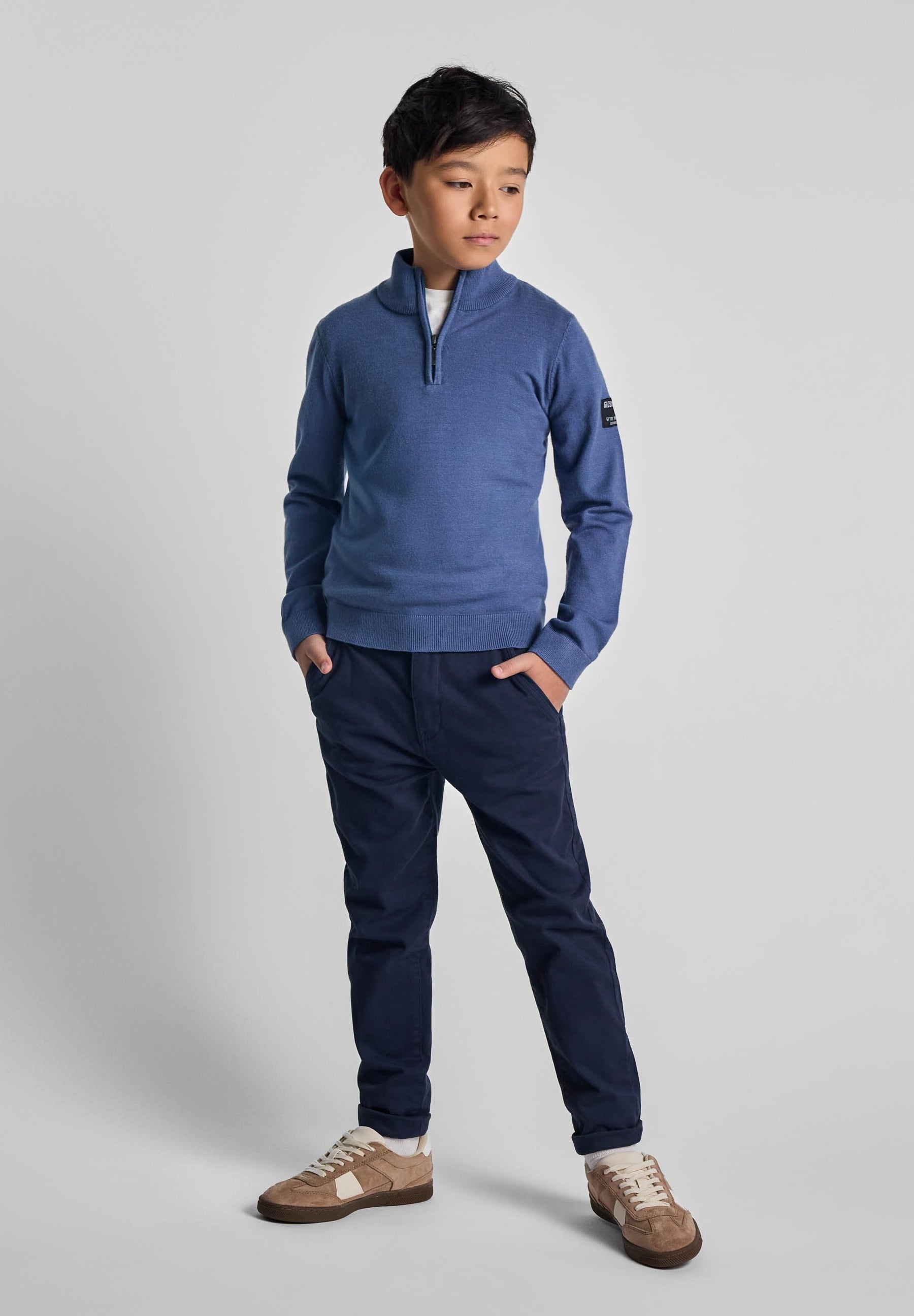 Boys half zip jumper in solid blue with ribbed cuffs, front view.