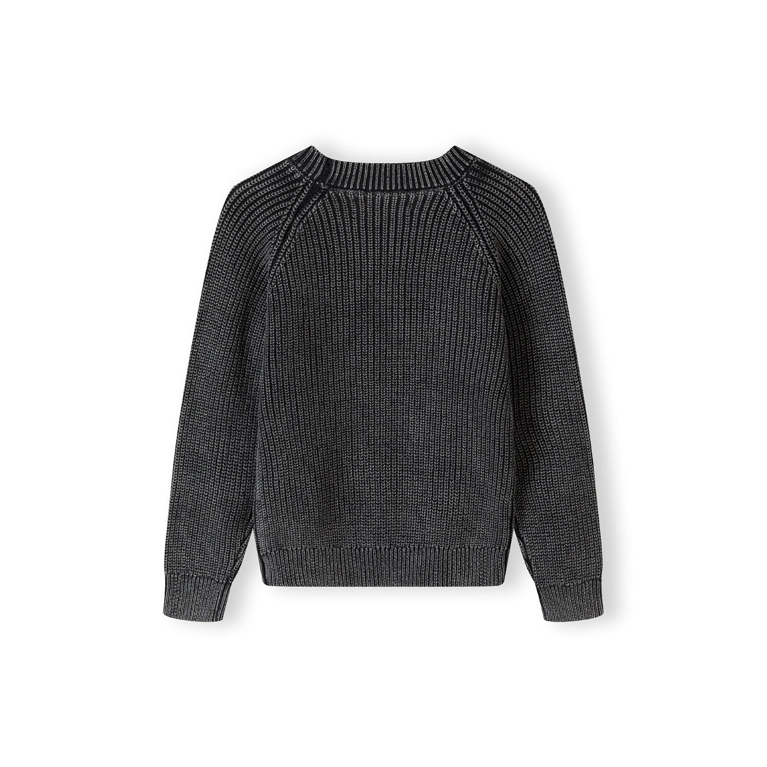 Black acid wash jumper laid flat showing raglan sleeve construction and ribbed knit texture against white background