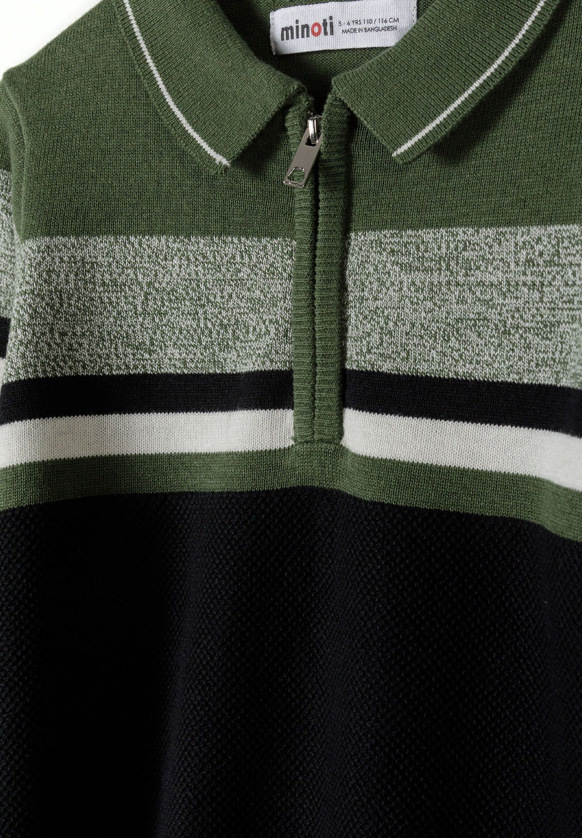 Black, green, grey and white quarter-zip collared jumper, collar and zip detail.