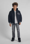 Boys grey denim jeans with rip-and-repair detailing, front view.