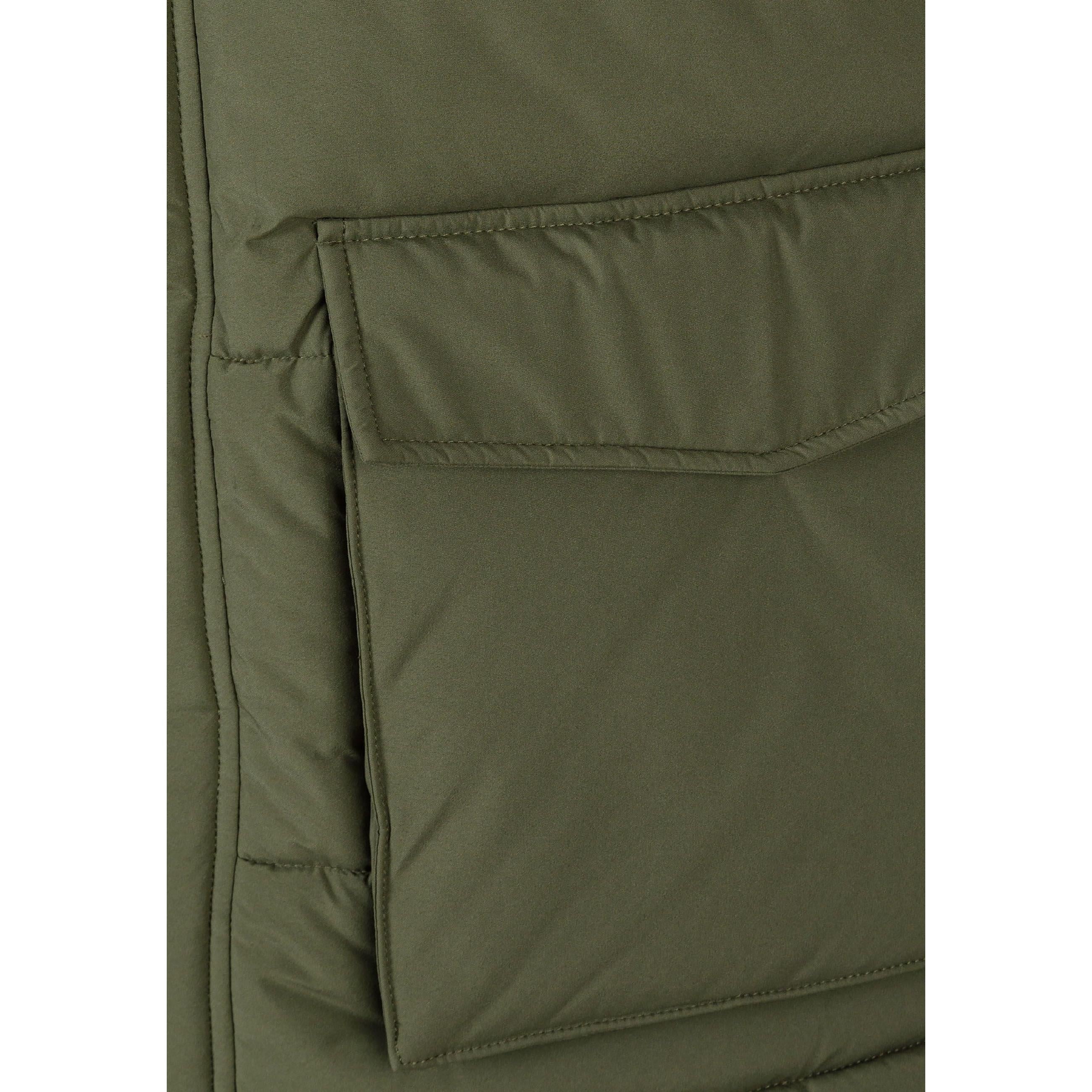 Close-up detail of khaki fabric texture showing brand patch with geometric logo design on quilted puffer jacket material