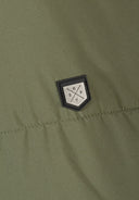 Detail of khaki jacket showing logo badge.