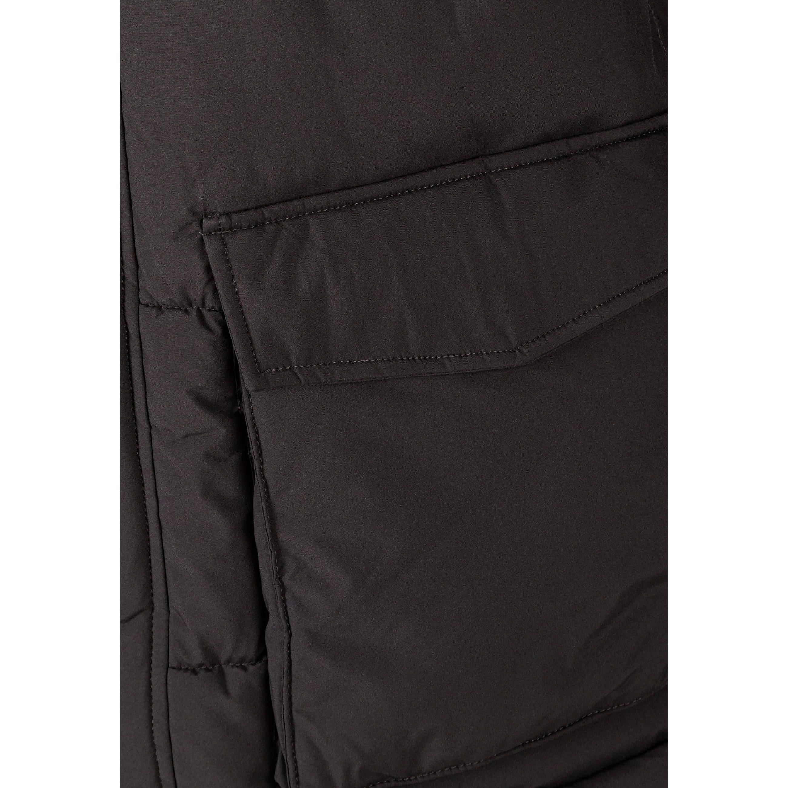 Close-up detail of grey padded jacket showing quilted pattern and small branded label patch