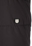 Detail of a men's long jacket featuring a logo badge.