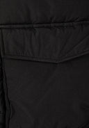 Detail of a black parka with a flap pocket and quilted texture.