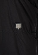 Detail of a black men's long parka featuring a logo badge.