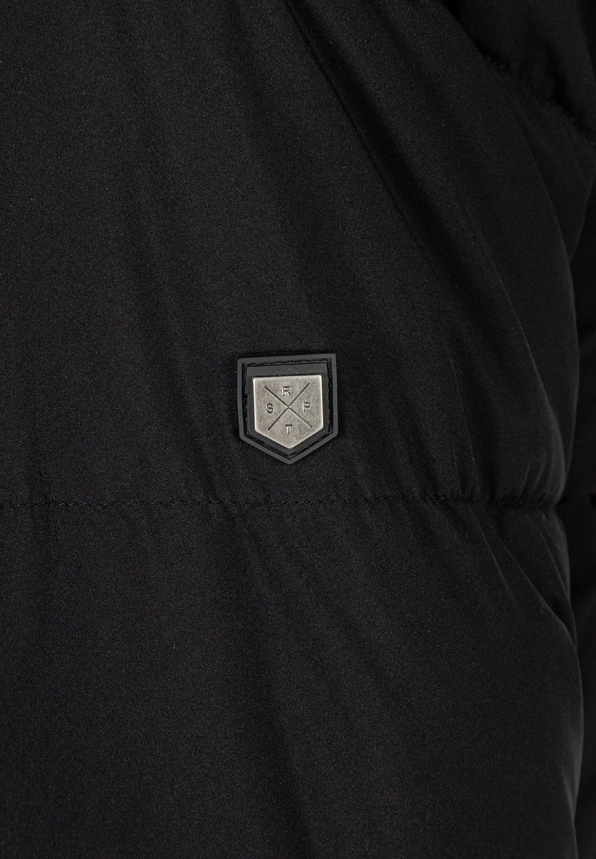 Close-up of the sleeve patch on the black padded parka.
