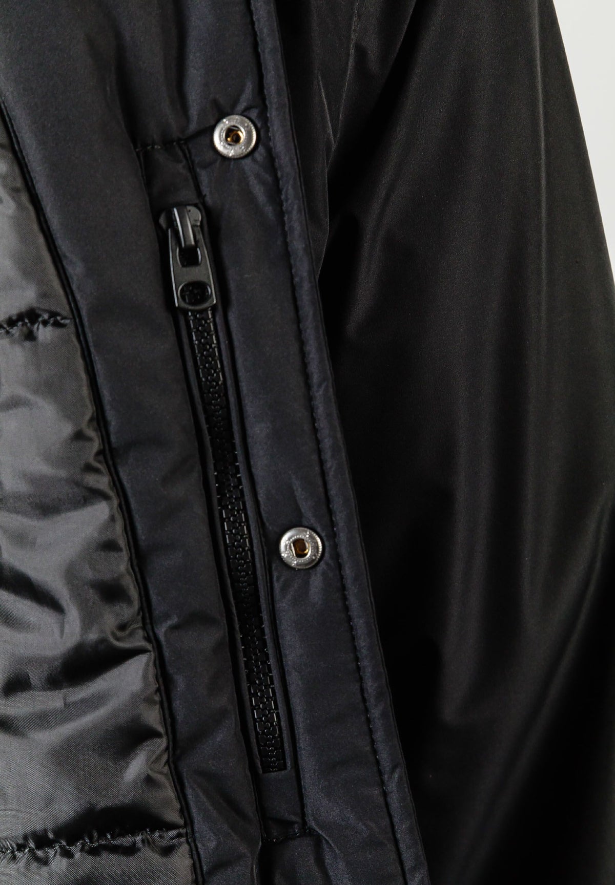 Close-up of the inside pocket on the black varsity jacket.