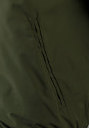 Detail of khaki men's baseball jacket showing side pocket.