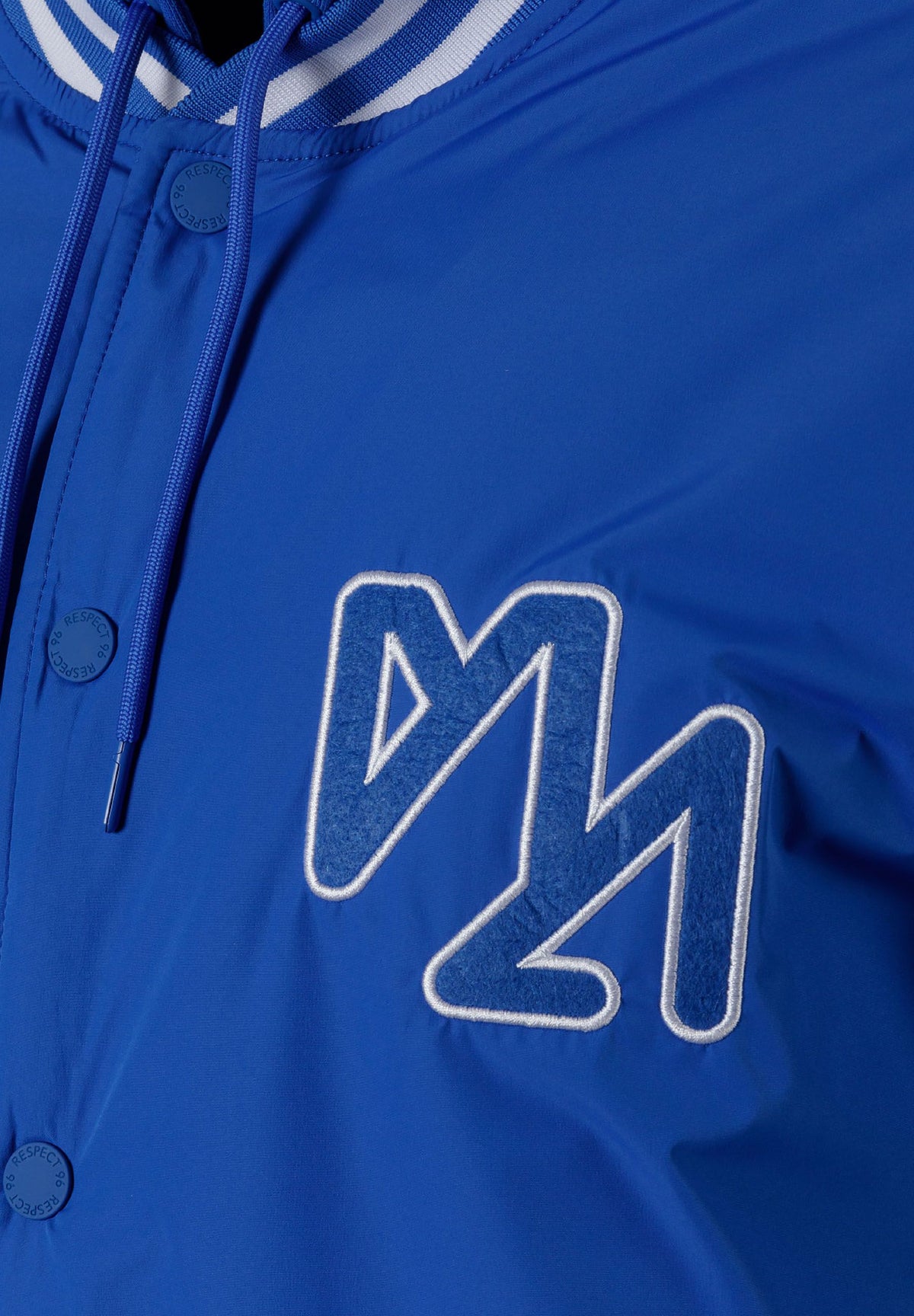 Close-up of the chest on the blue varsity jacket.
