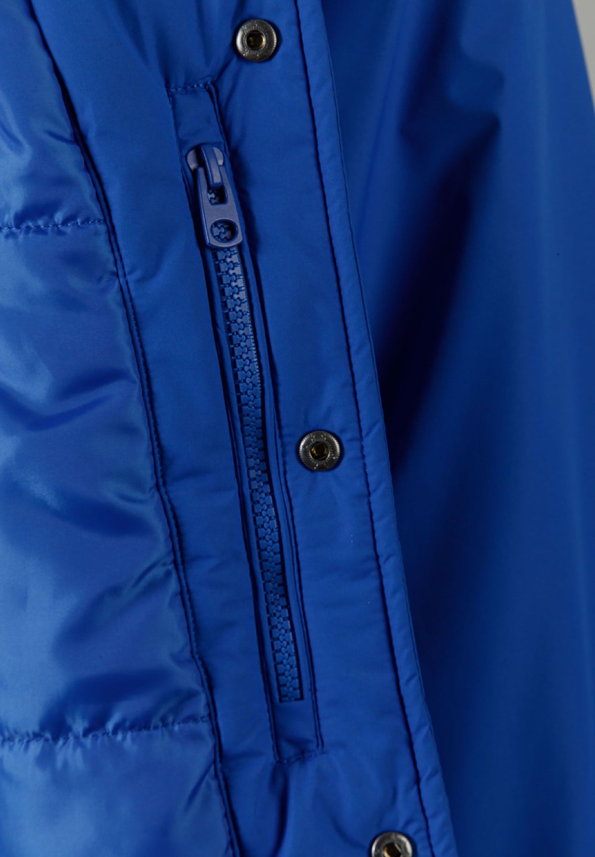 Close-up of the inside pocket on the blue varsity jacket.