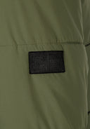 Detail of khaki men's ripstop jacket showing badge.