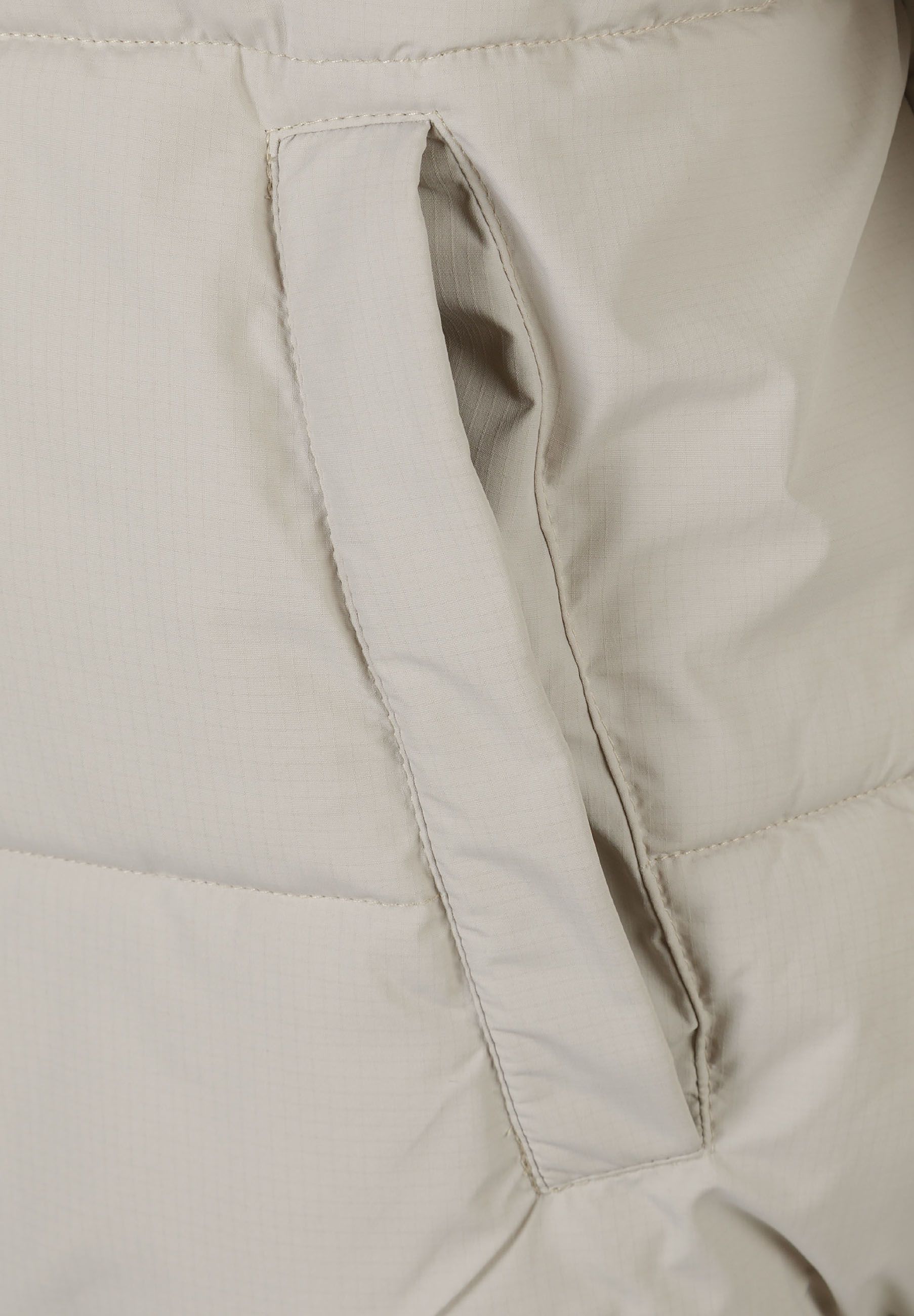 Detail of a men's grey ripstop jacket showing the pocket opening.