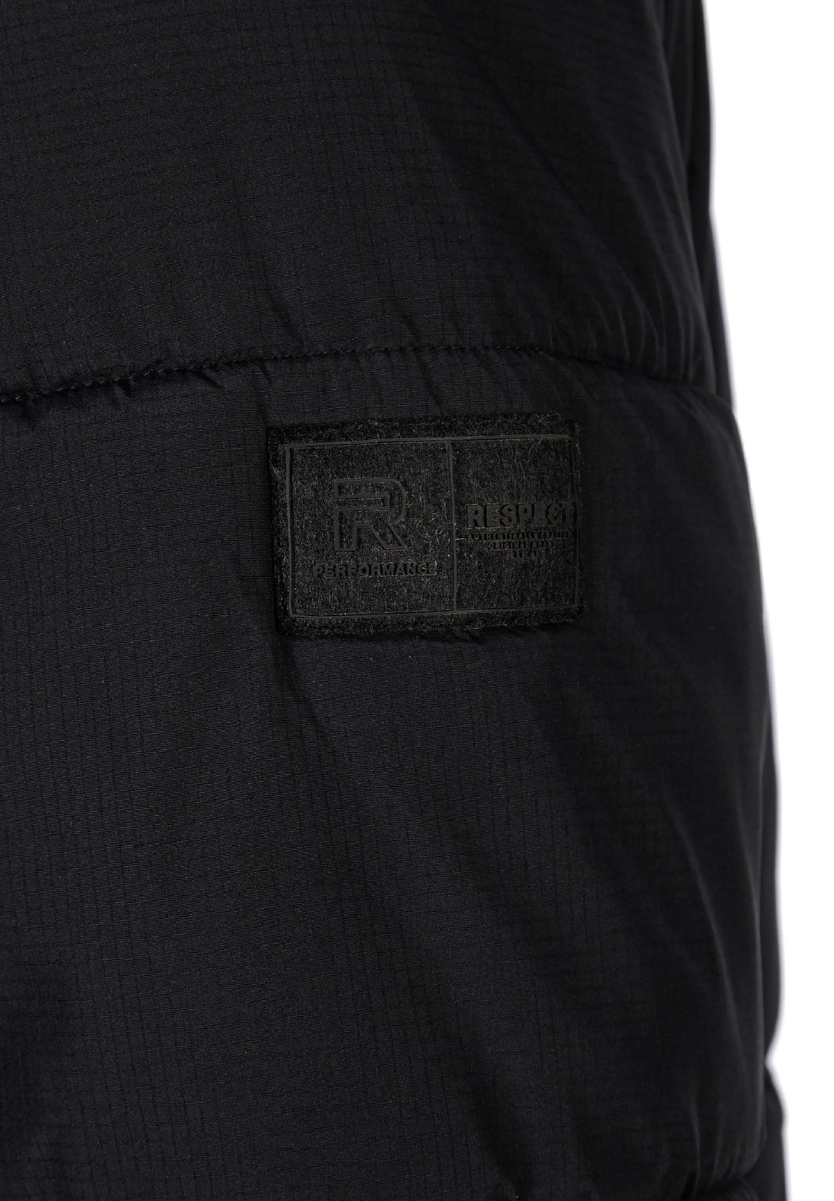 Close-up of the sleeve patch on the black puffer jacket.