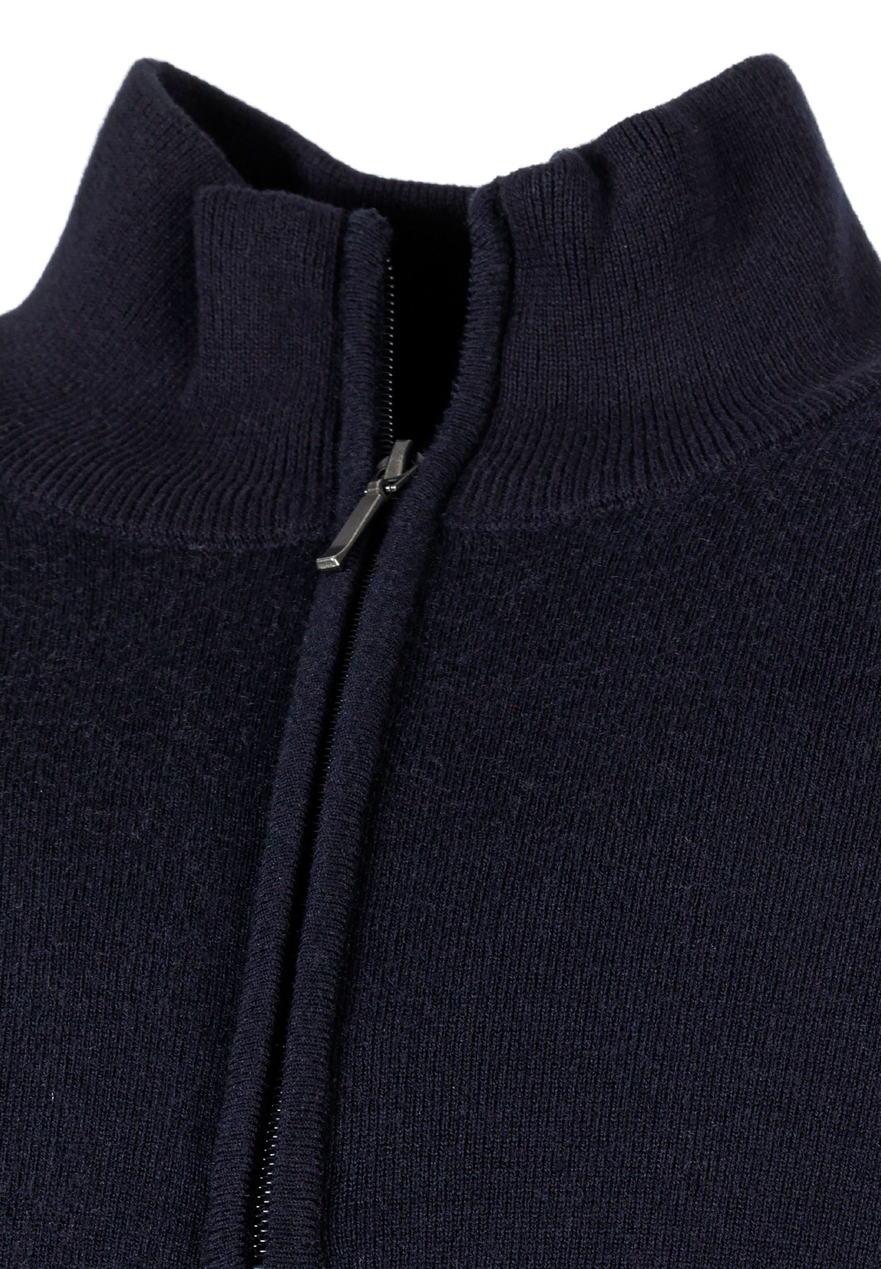 Close-up of a navy men's half zip jumper with a high collar and zip fastening.