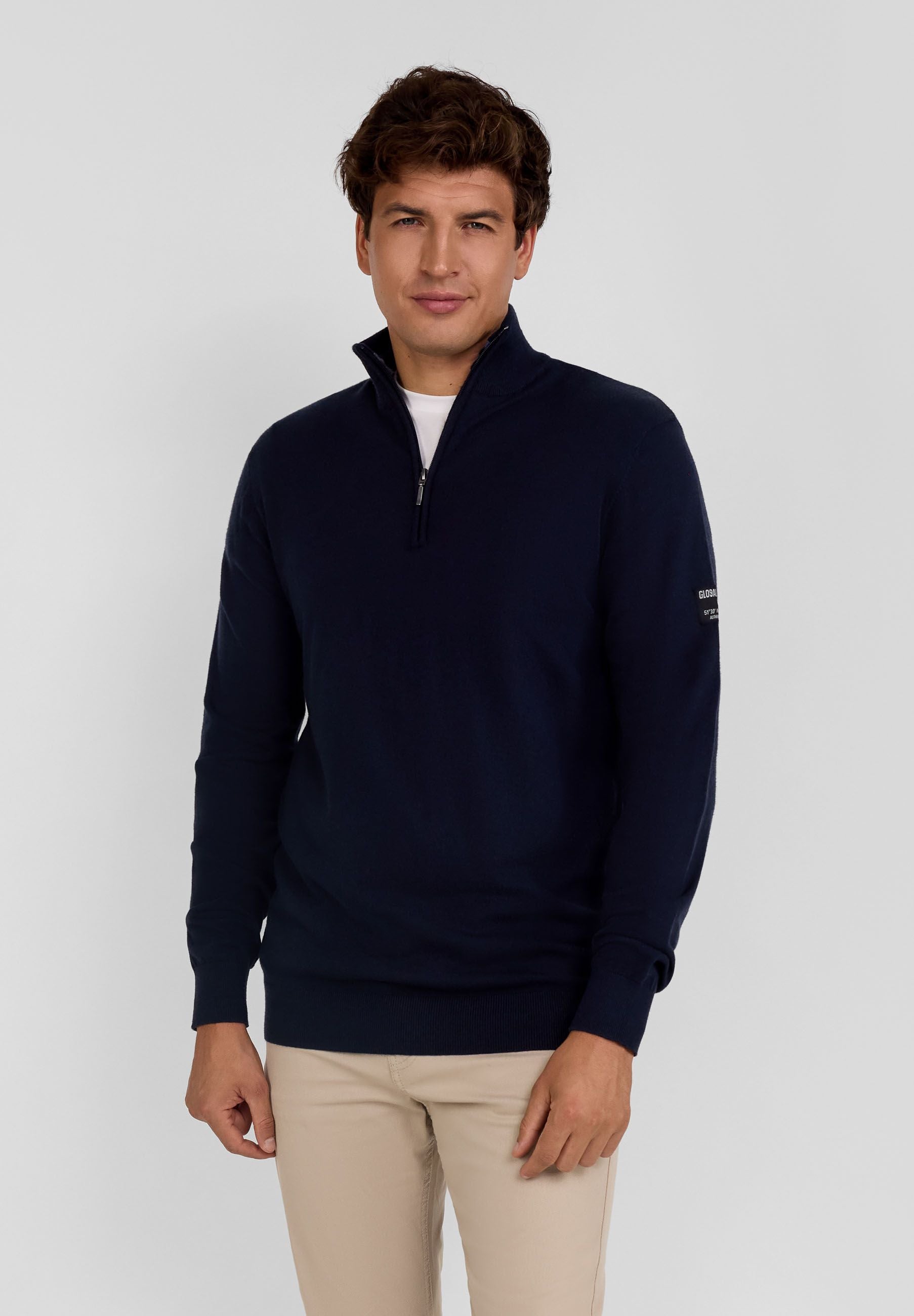 Men's half zip jumper in navy with adjustable collar and ribbed cuffs.