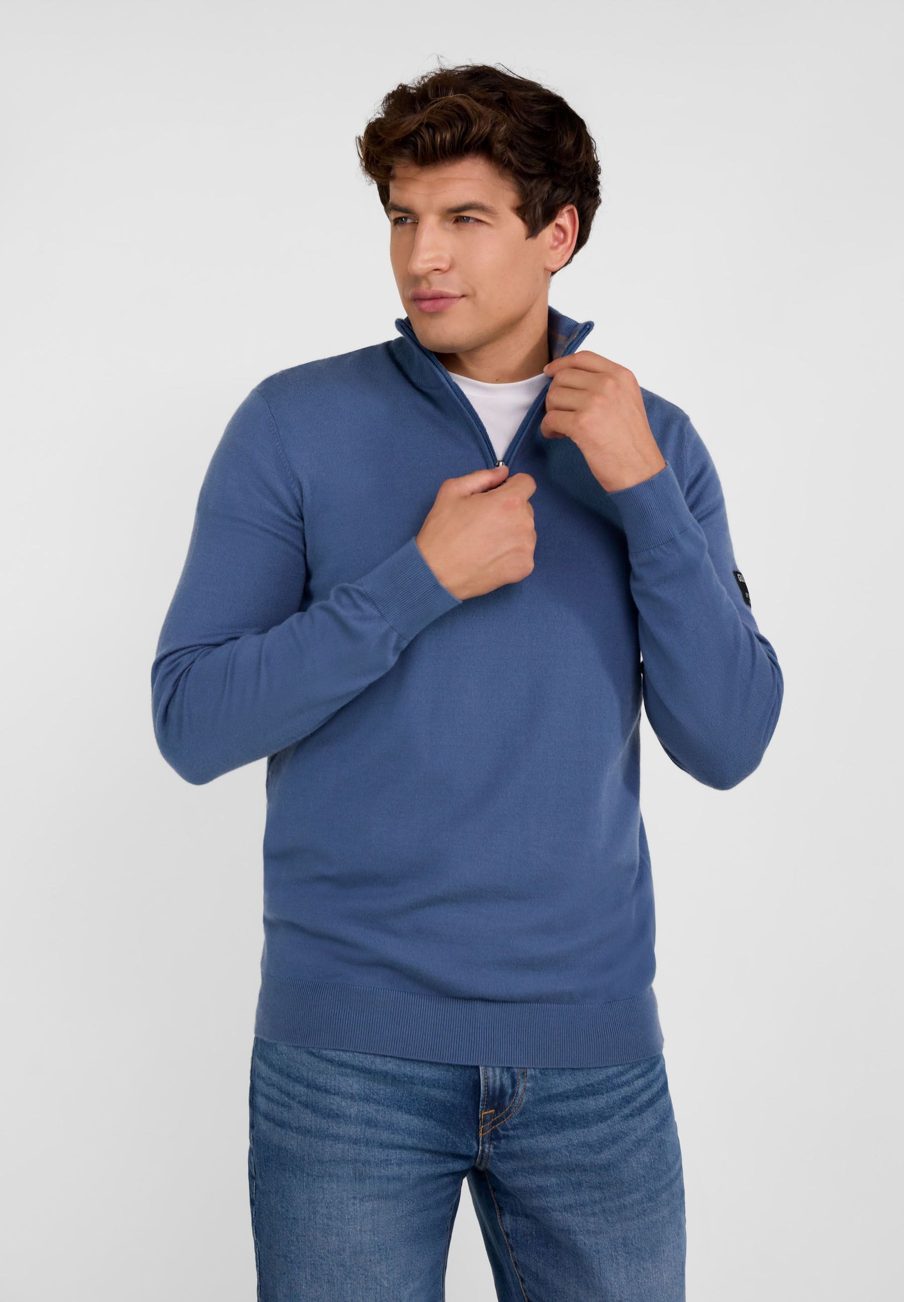 Men's blue half zip jumper with stand collar, ribbed cuffs, and flexible hem.