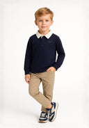Boys long sleeve navy polo shirt with contrasting collar and chest graphic, front view.