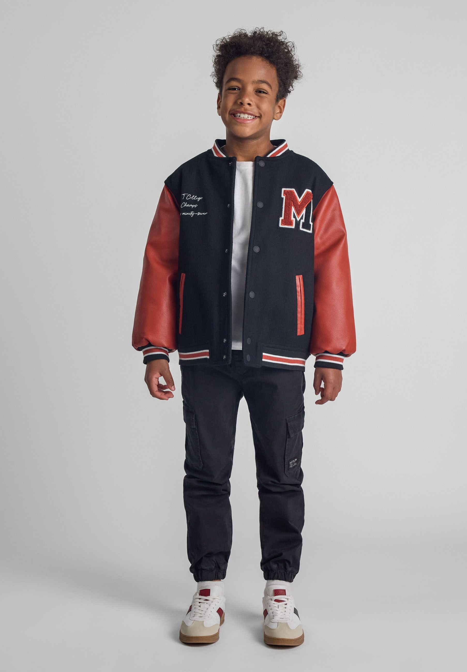 Boys black cargo trousers with elastic waist and ankle cuffs, featuring side and back pockets.