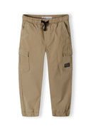 Boys cargo trousers in beige with elastic waist and side pockets, front view.
