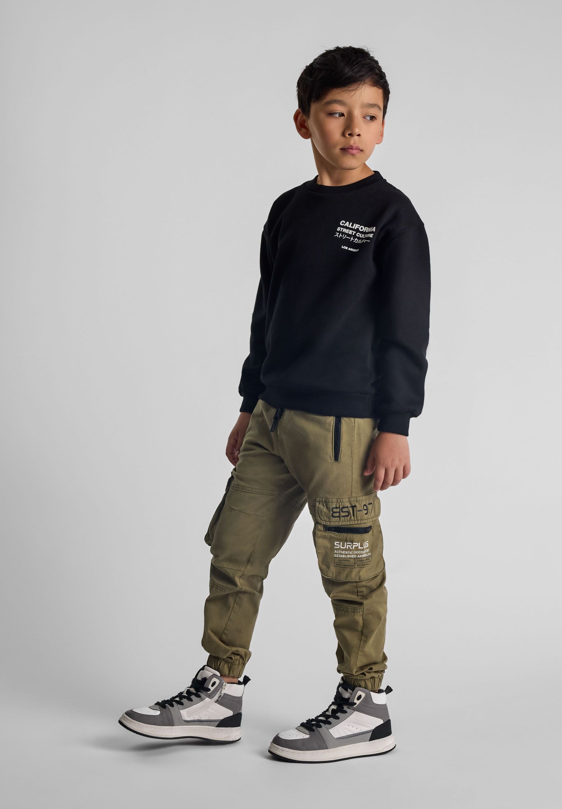 Boys cargo trousers in olive green, front view with zip pockets and elasticated ankle cuffs.