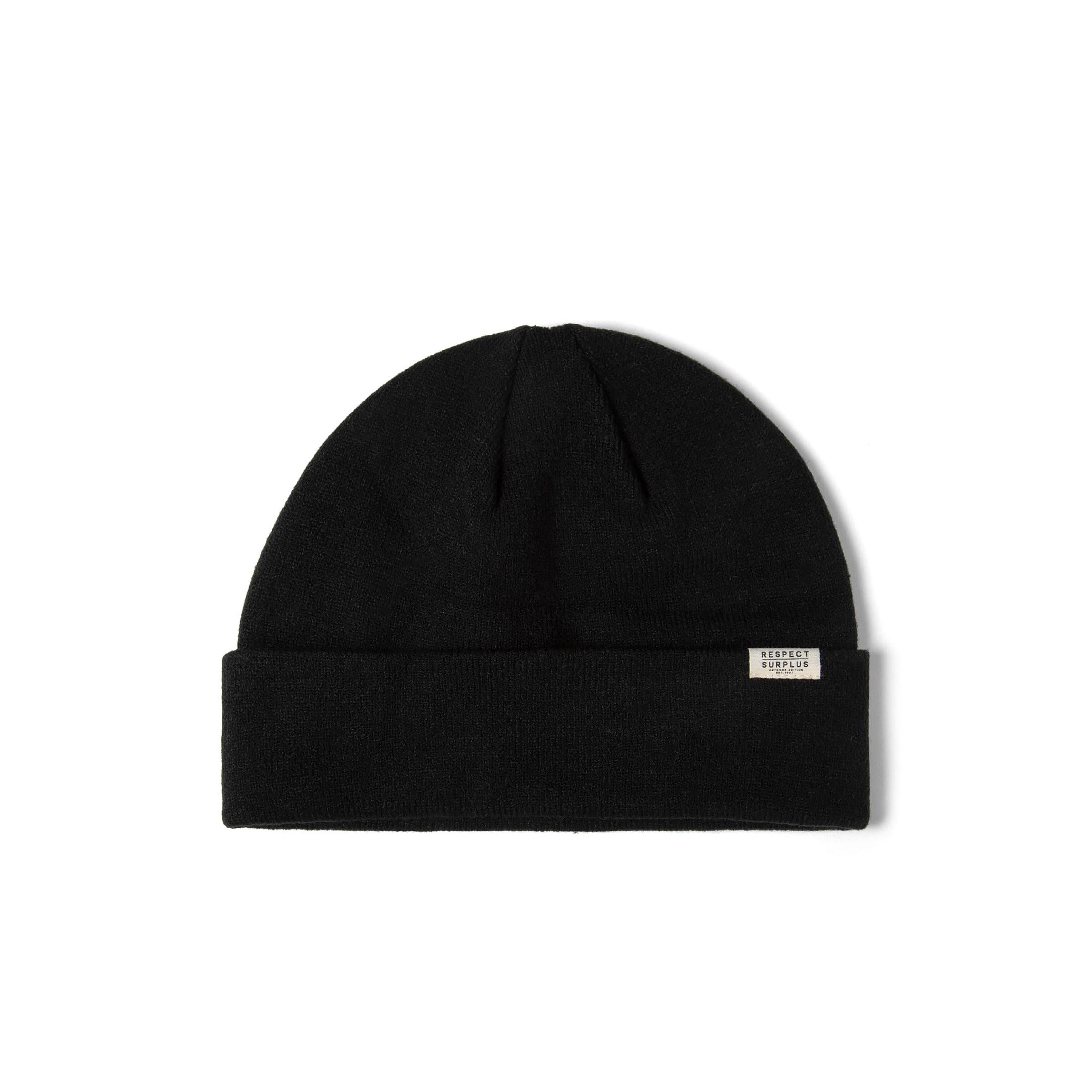 Black ribbed beanie hat with a fold-up cuff and a small "Respect Surplus" badge.