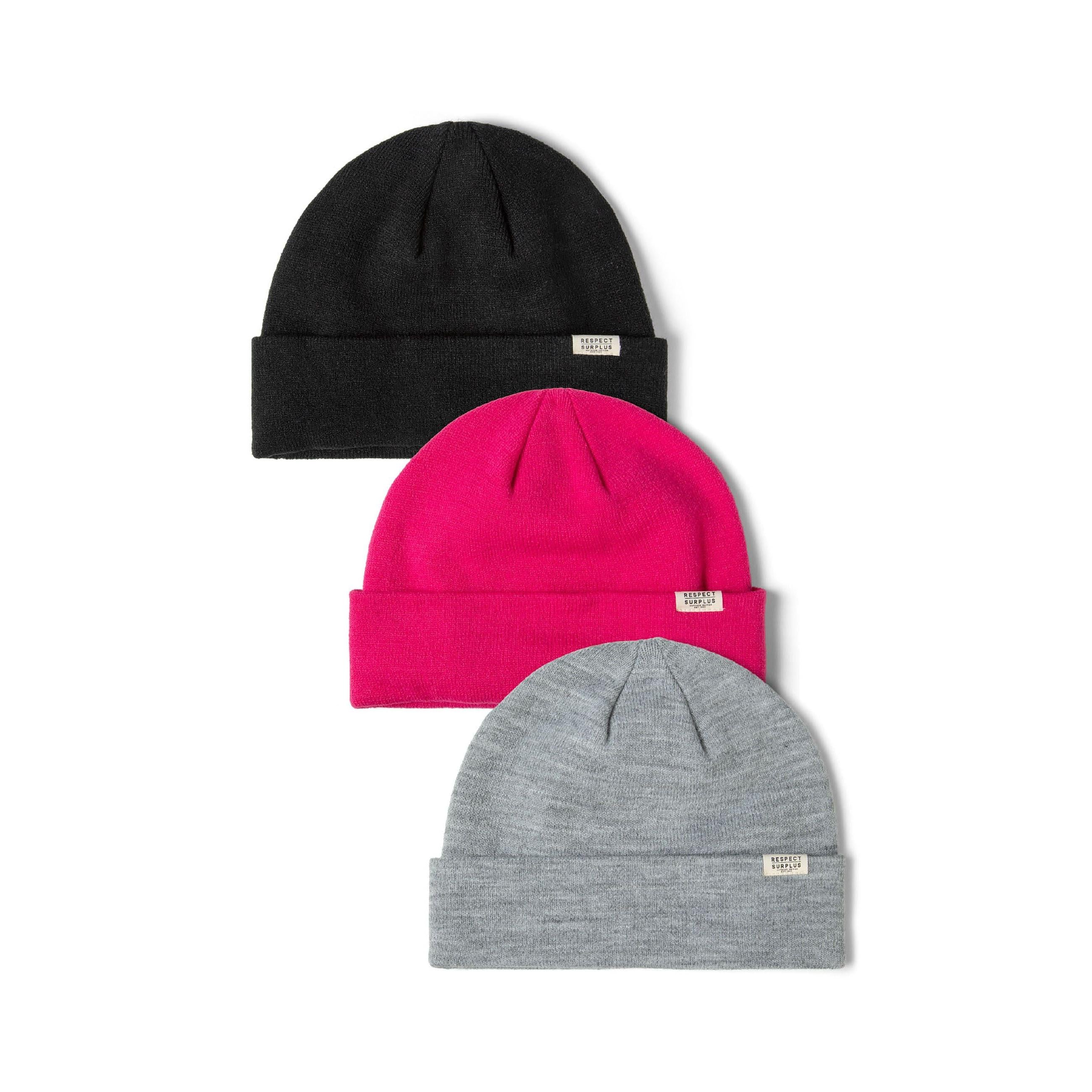 Three ribbed knit beanie hats: black, hot pink, and light grey, each with a subtle brand badge.