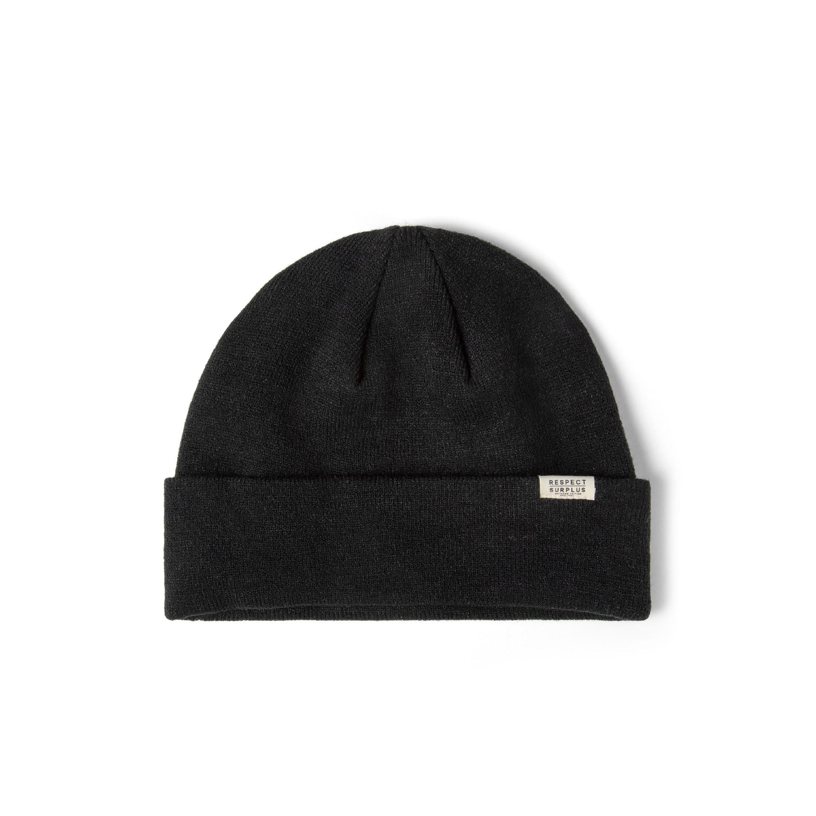 Black unisex ribbed knit beanie hat with a fold-up cuff and a subtle "RESPECT SURPLUS" badge.