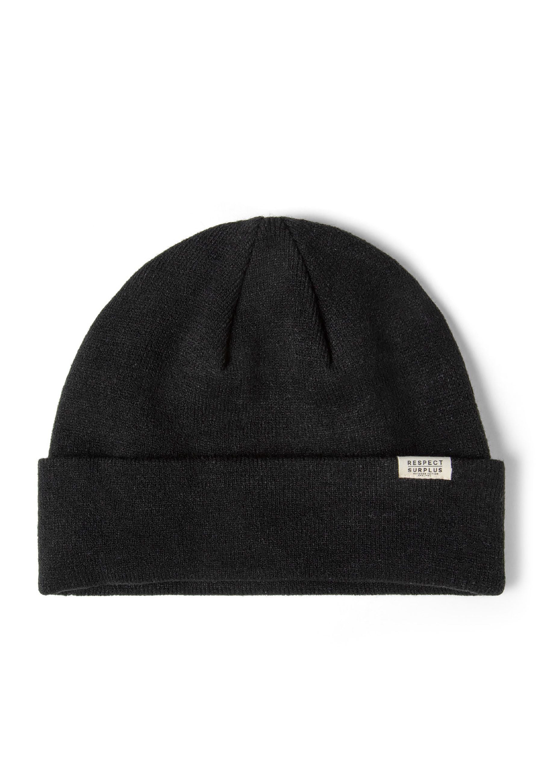 Close-up of a black ribbed beanie hat with a fold-up cuff and a discreet badge.