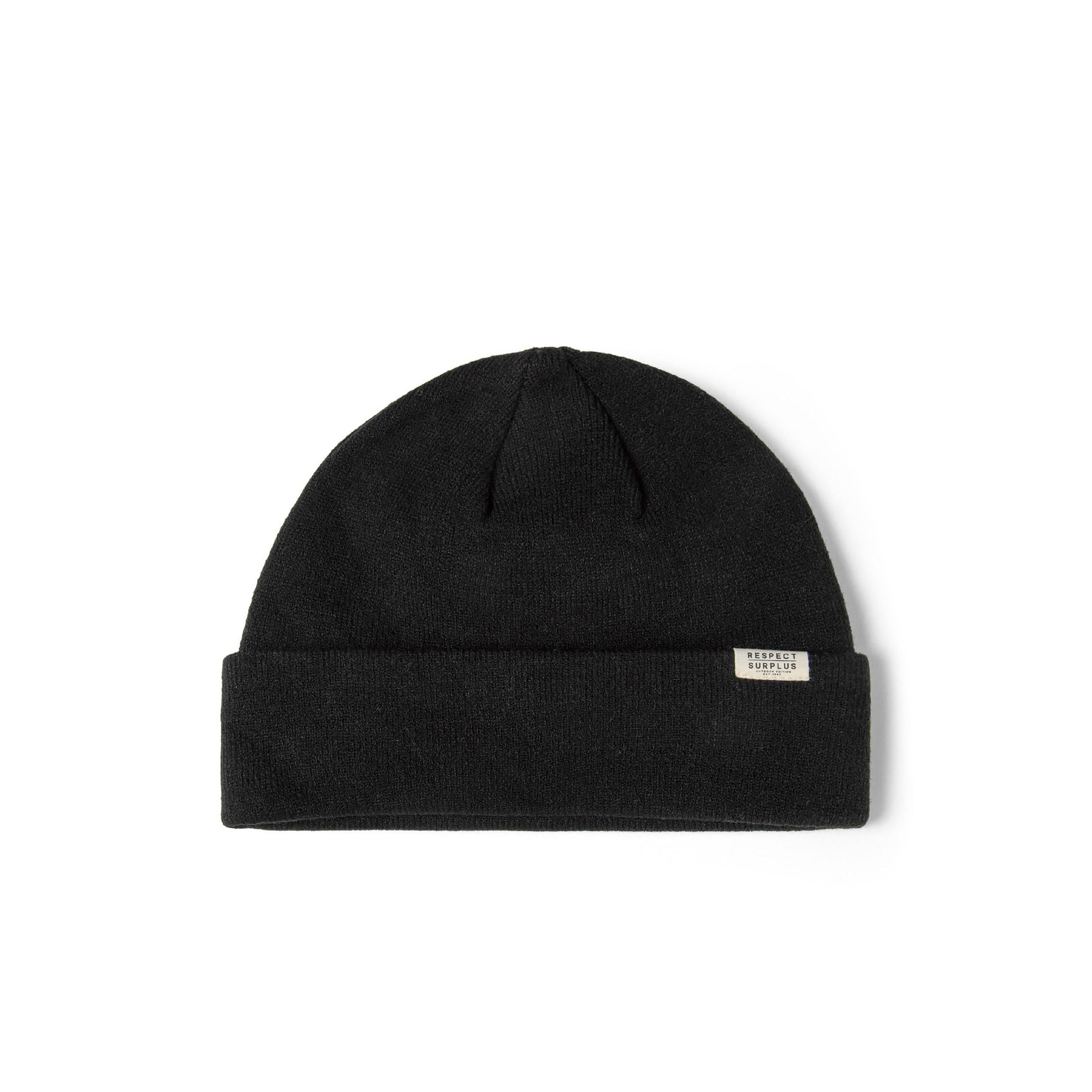 Black ribbed cuffed beanie hat with a subtle "RESPECT SURPLUS" badge on the cuff.