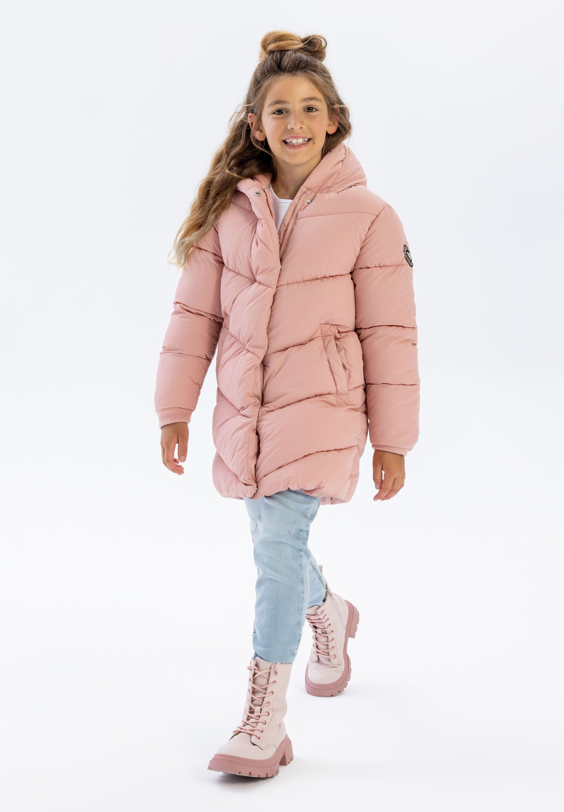 Girls long pink quilted winter jacket, front view, features fixed hood and side pockets.