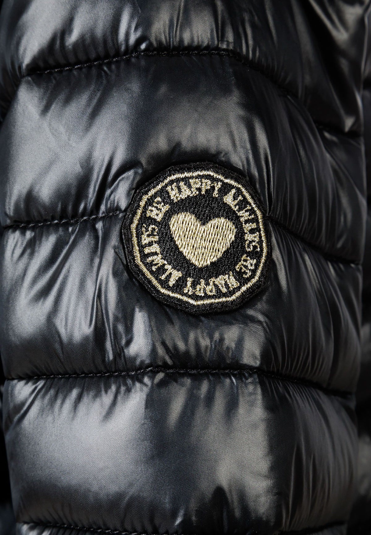 Close-up of the sleeve patch on the black puffer jacket.