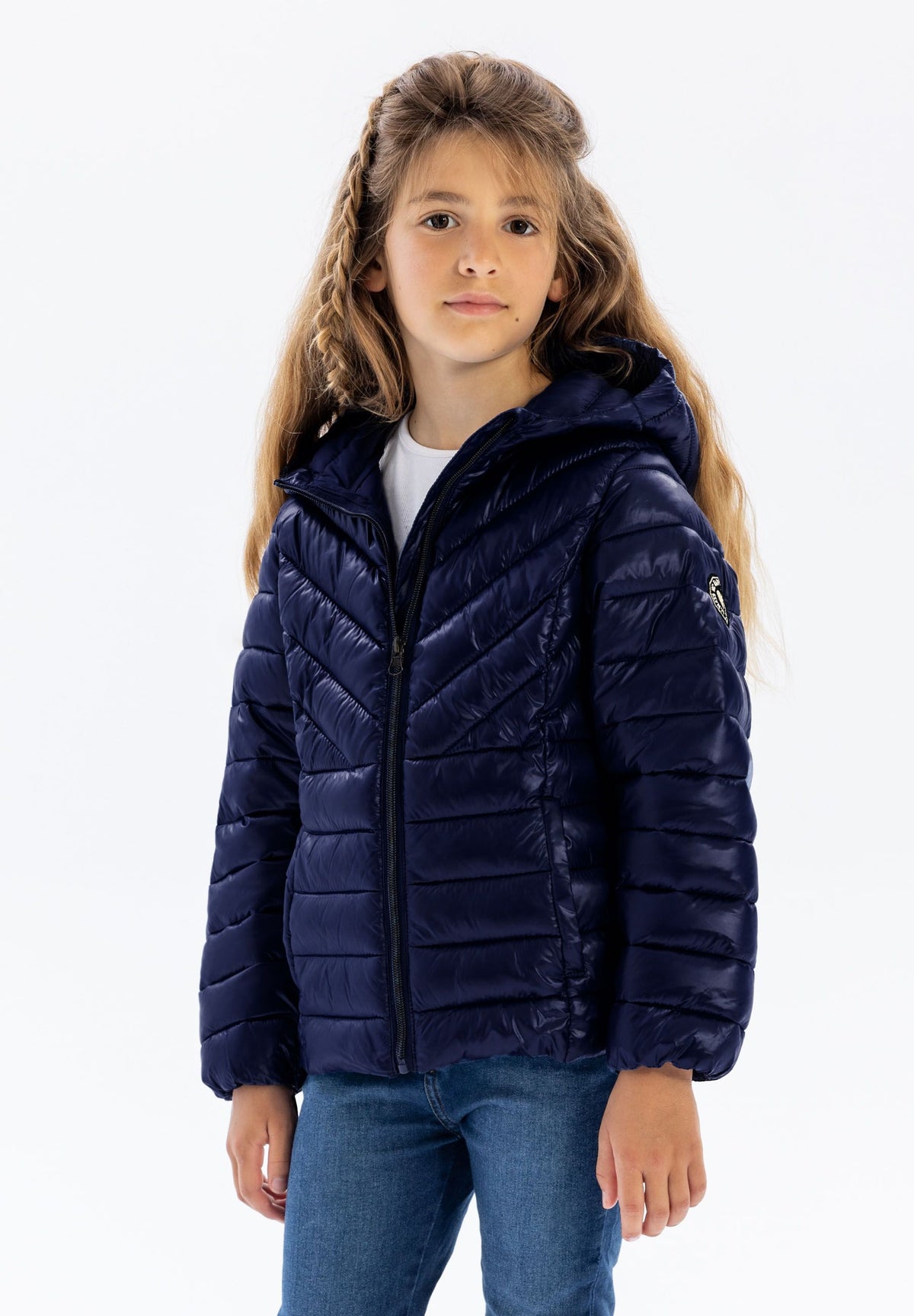 Girls' navy puffer jacket, shown worn.