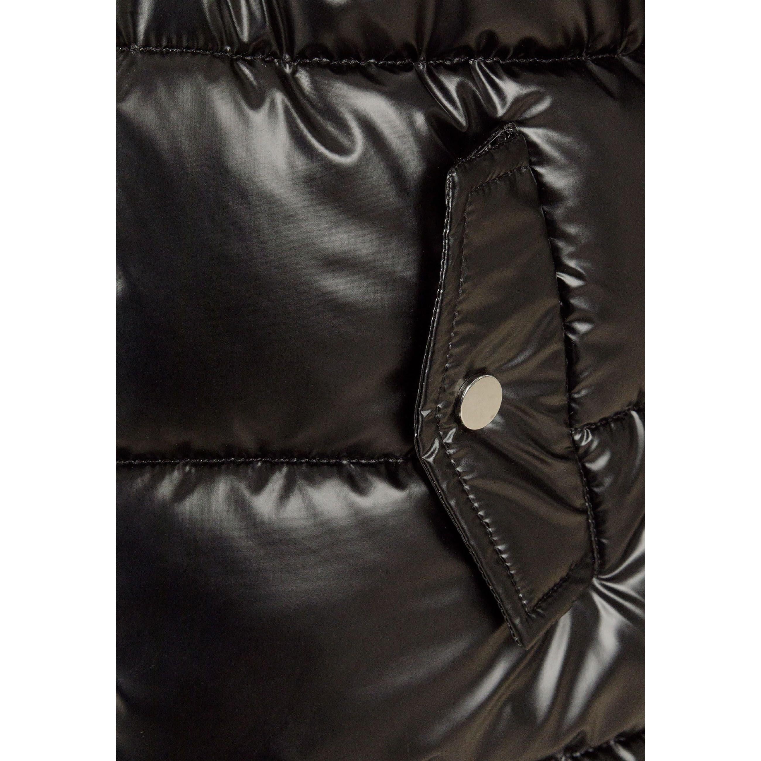 Close-up detail of black quilted parka showing chest pocket with snap closure and quilted texture against white background