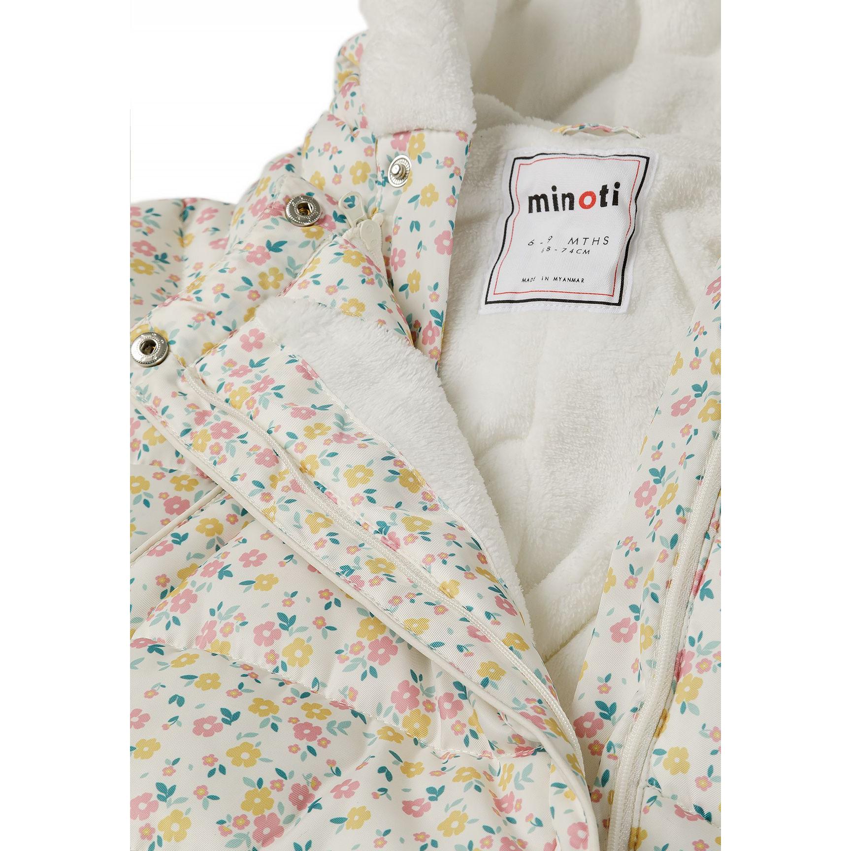 Close-up detail of Minoti label and double zip closure showing cream sherpa lining and floral print fabric