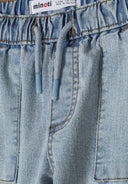 Close-up of light blue denim jogger cargo jeans with elasticated waistband and drawstring.