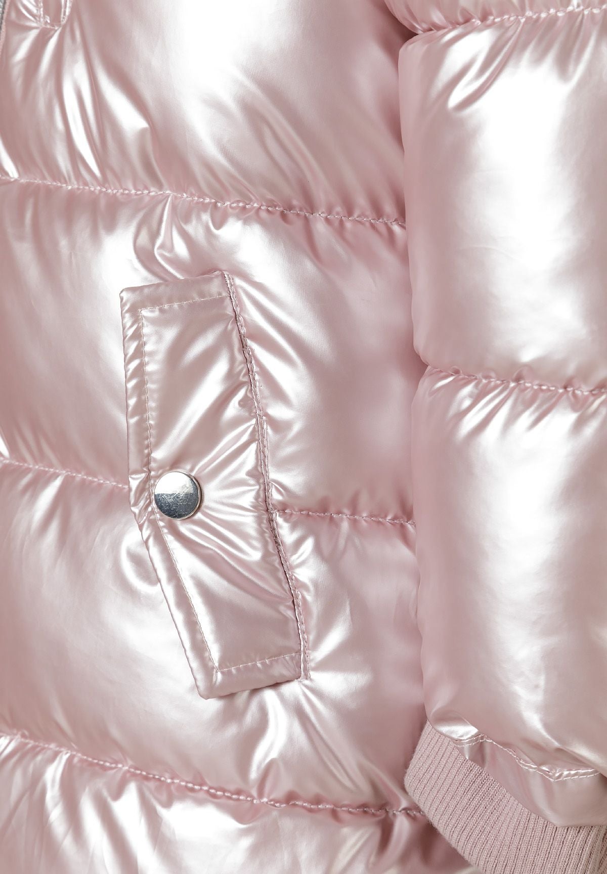 Close-up of a snap-fastened lower flap pocket on the glossy pale pink padded coat.